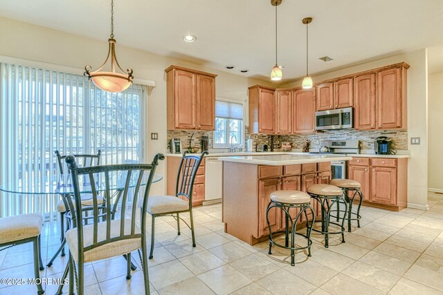 2 Kristen Ct, Franklin Twp, NJ 08873 - kitchen featuring light countertops, tasteful backsplash, appliances with stainless steel finishes, and a center island