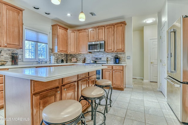 2 Kristen Ct, Franklin Twp, NJ 08873 - kitchen with a kitchen bar, stainless steel appliances, light countertops, and tasteful backsplash