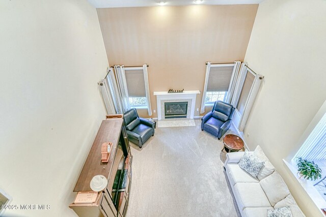 2 Kristen Ct, Franklin Twp, NJ 08873 - carpeted living room featuring a glass covered fireplace and a towering ceiling