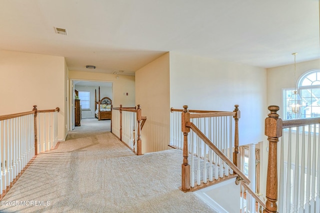 2 Kristen Ct, Franklin Twp, NJ 08873 - hall featuring an upstairs landing, visible vents, carpet floors, and a chandelier