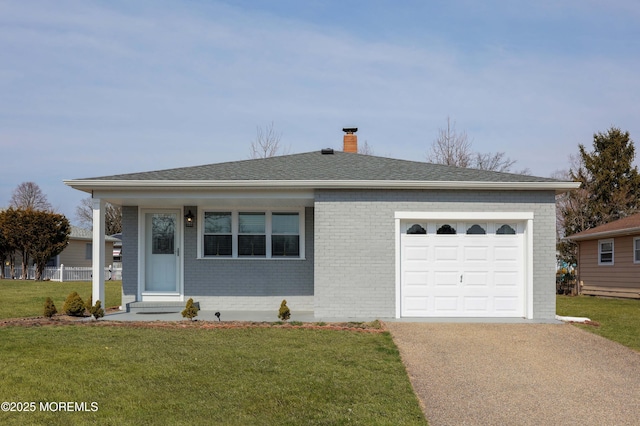 single story home featuring a front yard, brick siding, concrete driveway, and an attached garage