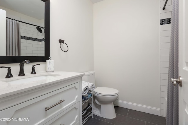 bathroom with baseboards, toilet, vanity, and a shower with curtain