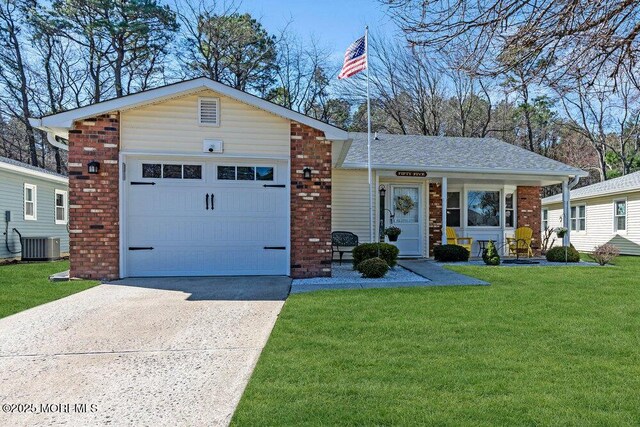 view of front of home featuring driveway, central AC, an attached garage, a front yard, and brick siding