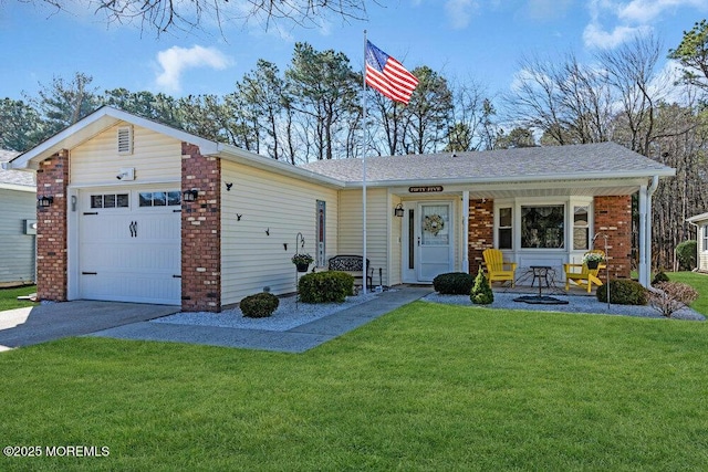 view of front of home featuring aphalt driveway, roof with shingles, a front yard, a garage, and brick siding