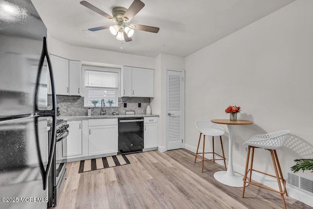 30 Turnberry Cir, Toms River, NJ 08753 - kitchen with a ceiling fan, light wood-style flooring, a sink, black appliances, and white cabinetry