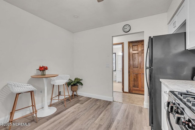 30 Turnberry Cir, Toms River, NJ 08753 - kitchen featuring baseboards, light wood-type flooring, freestanding refrigerator, white cabinets, and gas stove