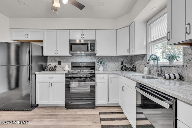 30 Turnberry Cir, Toms River, NJ 08753 - kitchen featuring light stone counters, backsplash, black appliances, and a sink