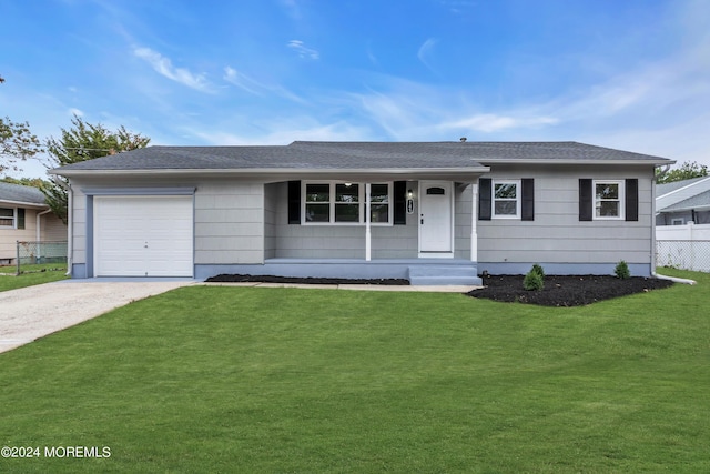 ranch-style home with driveway, a front lawn, fence, roof with shingles, and an attached garage