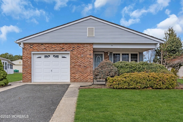 view of front of house featuring a front yard, an attached garage, brick siding, and driveway