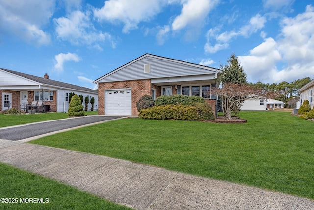 view of front of property with aphalt driveway, brick siding, a garage, and a front lawn