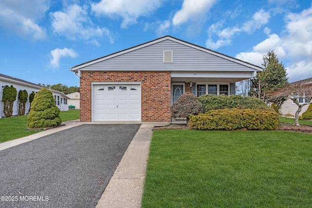 view of front of house featuring a garage, driveway, brick siding, and a front lawn