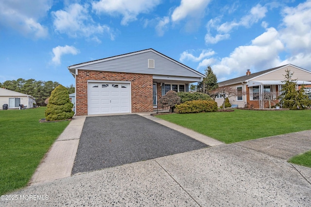 view of front of home featuring a front yard, brick siding, a garage, and driveway