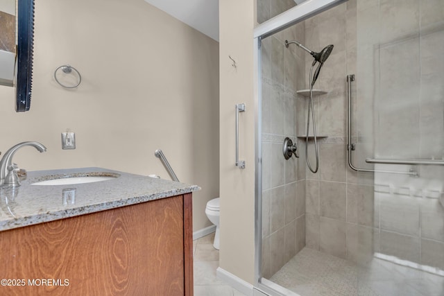 full bath featuring vanity, baseboards, tiled shower, tile patterned floors, and toilet