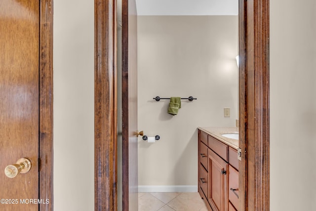 bathroom featuring tile patterned floors, vanity, and baseboards