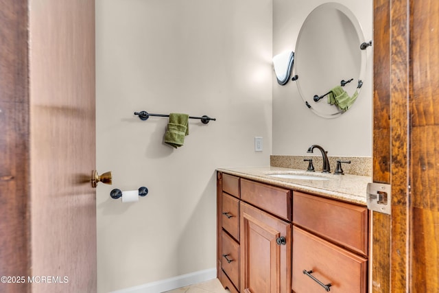 bathroom featuring baseboards, vanity, and tile patterned flooring