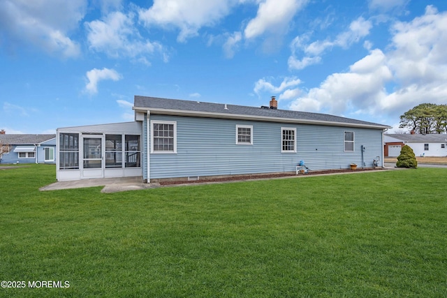 rear view of property with a lawn, a chimney, and a sunroom