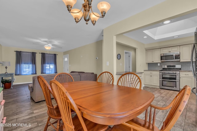 dining room featuring recessed lighting, ceiling fan with notable chandelier, and baseboards