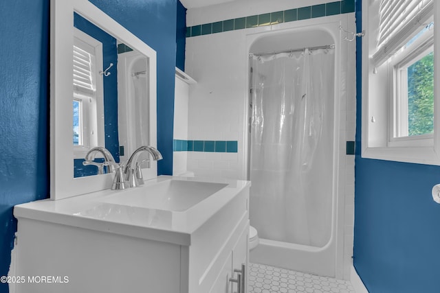 bathroom featuring tile patterned flooring, curtained shower, and vanity