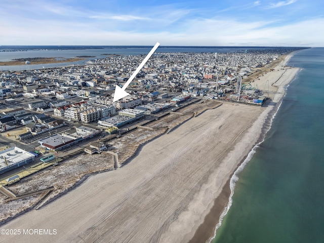 aerial view with a water view and a view of the beach