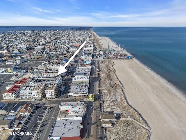 birds eye view of property with a water view and a view of the beach