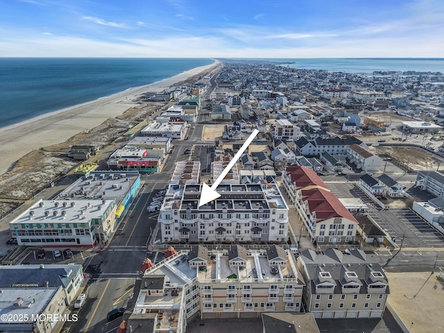 birds eye view of property with a view of the beach and a water view