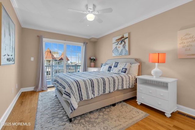 bedroom featuring crown molding, baseboards, wood finished floors, a ceiling fan, and access to outside