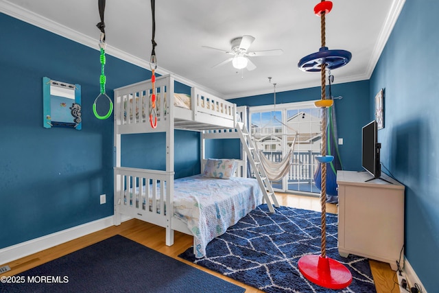 bedroom featuring wood finished floors, baseboards, and ornamental molding