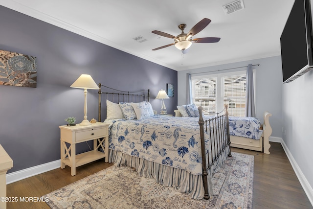 bedroom featuring visible vents, baseboards, and wood finished floors