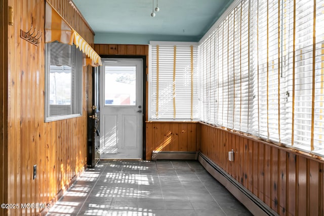 unfurnished sunroom featuring a baseboard radiator