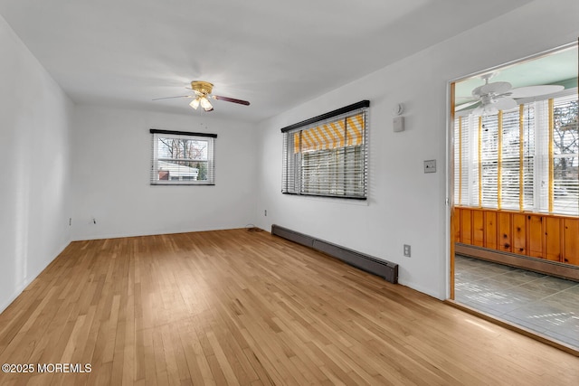 unfurnished room with light wood-style flooring, baseboard heating, and ceiling fan