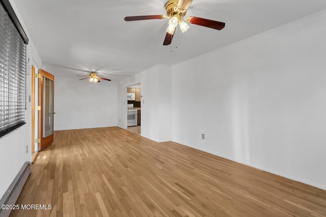 unfurnished living room featuring baseboard heating, a ceiling fan, and light wood-style floors