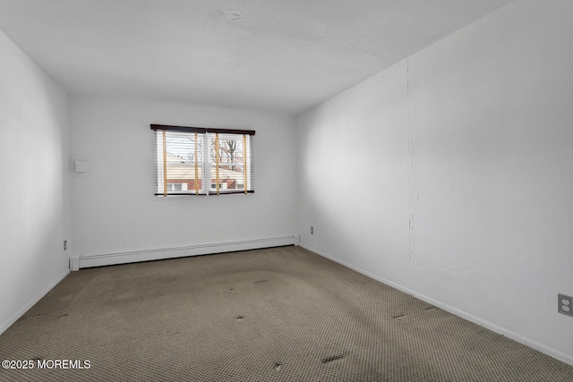 carpeted empty room featuring a baseboard heating unit and baseboards