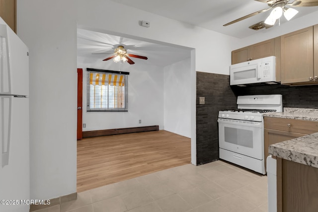 kitchen with light tile patterned floors, white appliances, ceiling fan, and a baseboard radiator