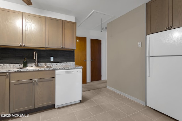 kitchen featuring white appliances, light tile patterned flooring, backsplash, and a sink