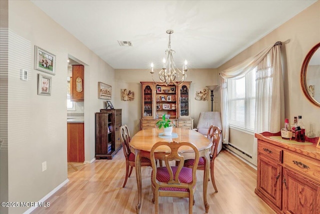 dining room with baseboards, visible vents, light wood-style floors, a baseboard heating unit, and a chandelier