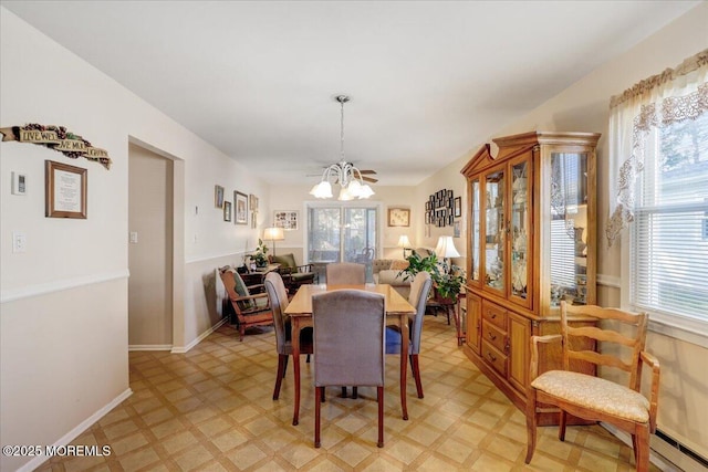 dining space featuring baseboard heating, a notable chandelier, and a wealth of natural light