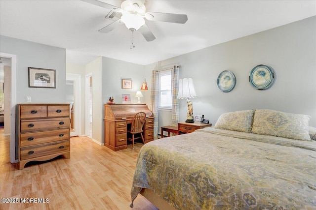 bedroom with light wood finished floors, visible vents, baseboards, and a ceiling fan