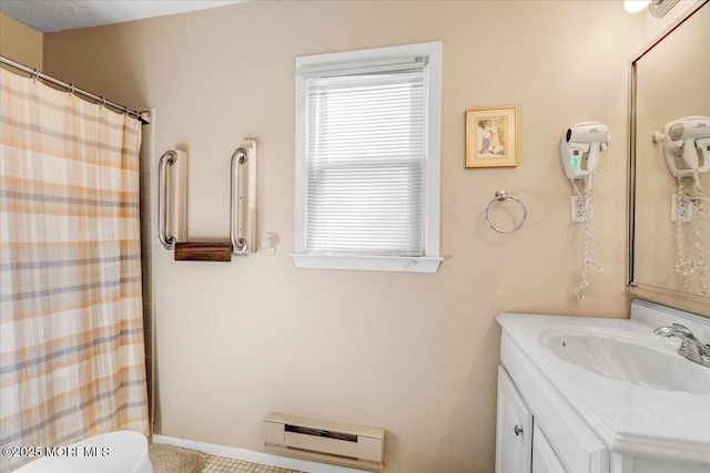 full bathroom featuring a shower with curtain, baseboard heating, vanity, and toilet