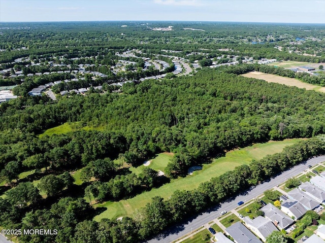 drone / aerial view featuring a wooded view