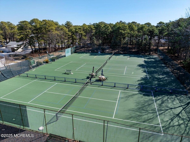 view of tennis court featuring fence