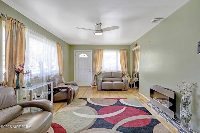 72 Mount Matterhorn Ln, Toms River, NJ 08753 - living area with a ceiling fan, wood finished floors, visible vents, and a fireplace