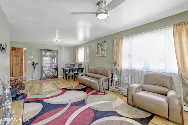 72 Mount Matterhorn Ln, Toms River, NJ 08753 - living area featuring a baseboard heating unit, wood finished floors, and ceiling fan