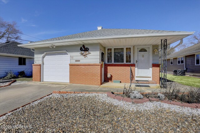 72 Mount Matterhorn Ln, Toms River, NJ 08753 - view of front of property featuring brick siding, driveway, an attached garage, and roof with shingles