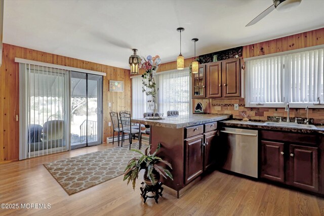 72 Mount Matterhorn Ln, Toms River, NJ 08753 - kitchen with a peninsula, a sink, wood walls, stainless steel dishwasher, and light wood-type flooring