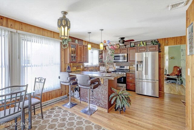 72 Mount Matterhorn Ln, Toms River, NJ 08753 - kitchen with light wood-style floors, brown cabinetry, visible vents, and appliances with stainless steel finishes