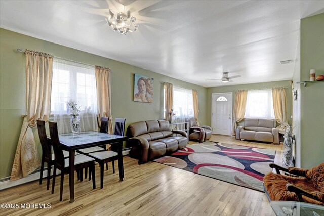 72 Mount Matterhorn Ln, Toms River, NJ 08753 - living room with visible vents, a baseboard heating unit, wood finished floors, and a ceiling fan