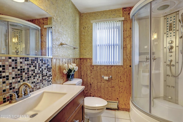 72 Mount Matterhorn Ln, Toms River, NJ 08753 - bathroom with tile patterned floors, toilet, a shower with door, wainscoting, and baseboard heating