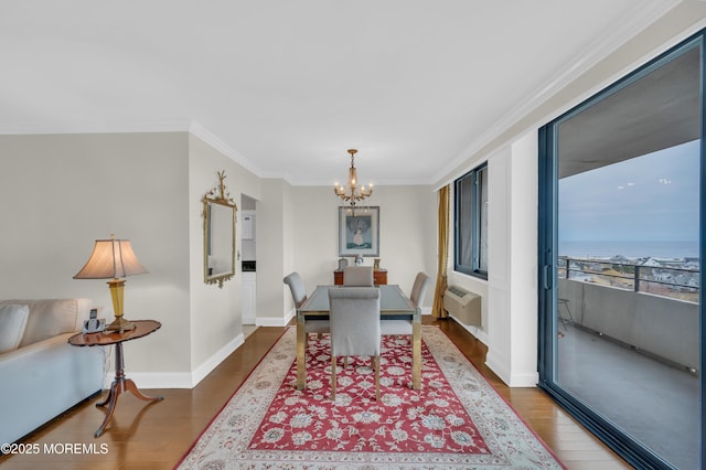 dining space with dark wood-type flooring, a notable chandelier, an AC wall unit, ornamental molding, and baseboards