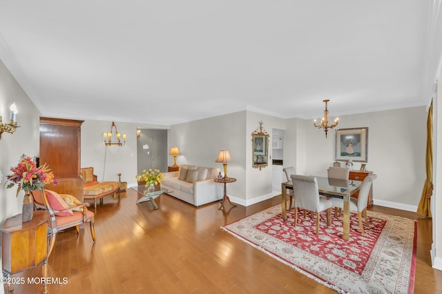 living room featuring wood finished floors, baseboards, and a chandelier