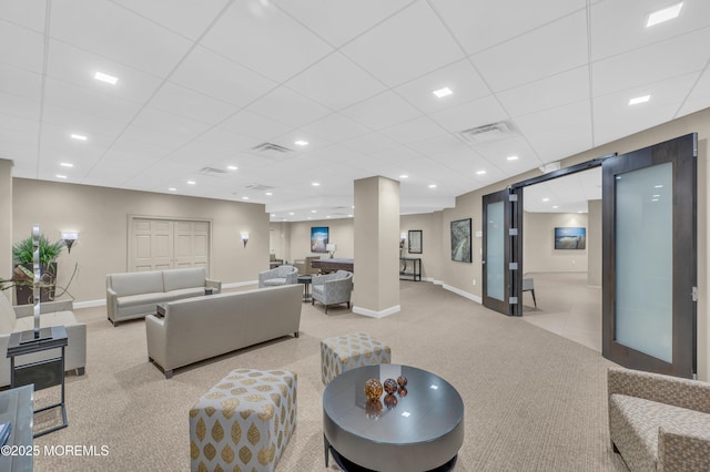 living area with visible vents, baseboards, light colored carpet, recessed lighting, and a paneled ceiling